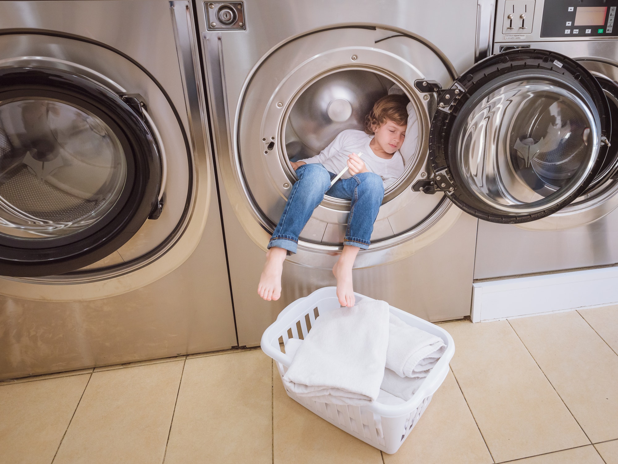 Boy sleeping in washing machine