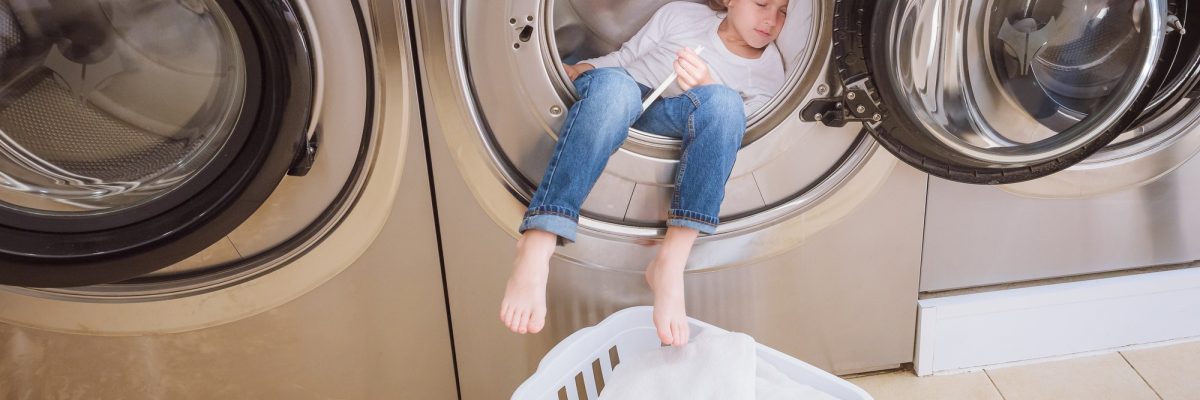Boy sleeping in washing machine